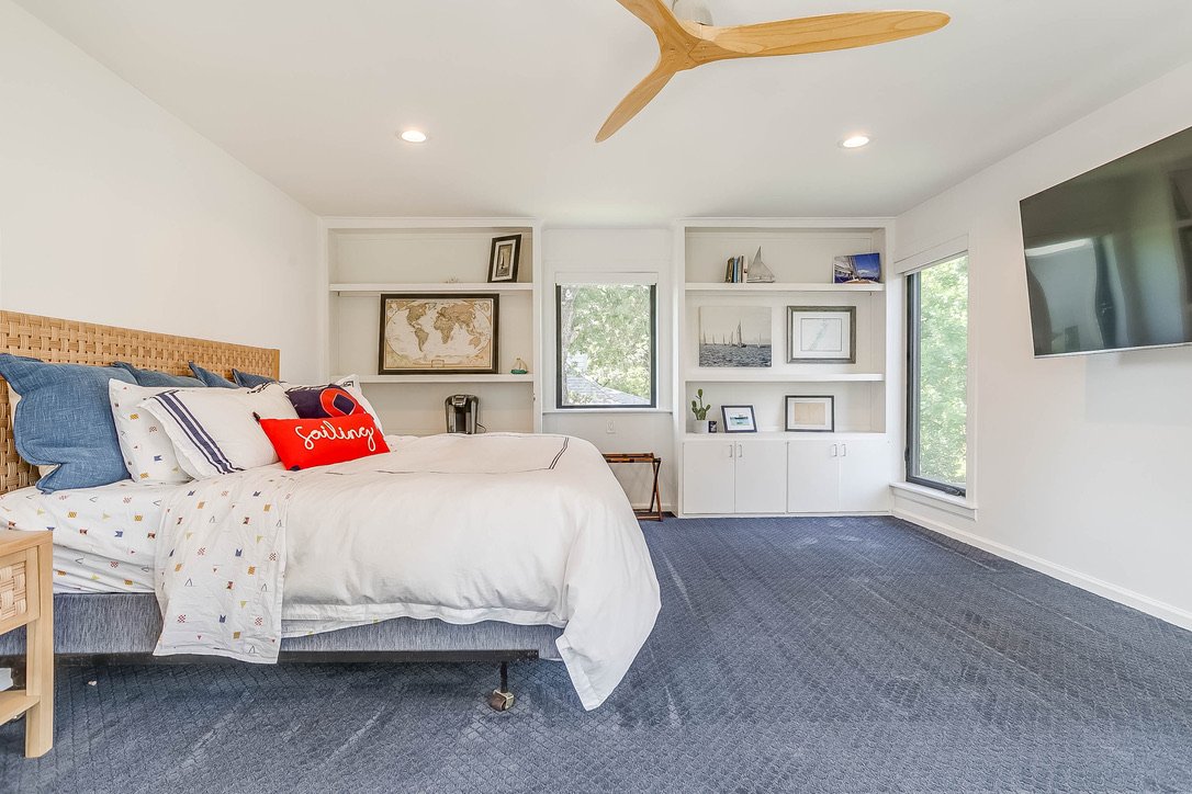 Bedroom with a large bed TV and outdoor view — Luxury Mountain Retreat