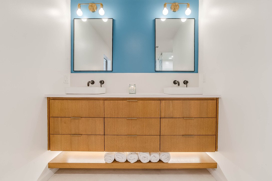 Modern bathroom vanity with lighted mirrors — Luxury Mountain Retreat