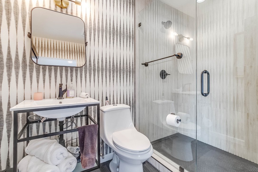 Modern bathroom with a sink mirror and toilet — Luxury Mountain Retreat