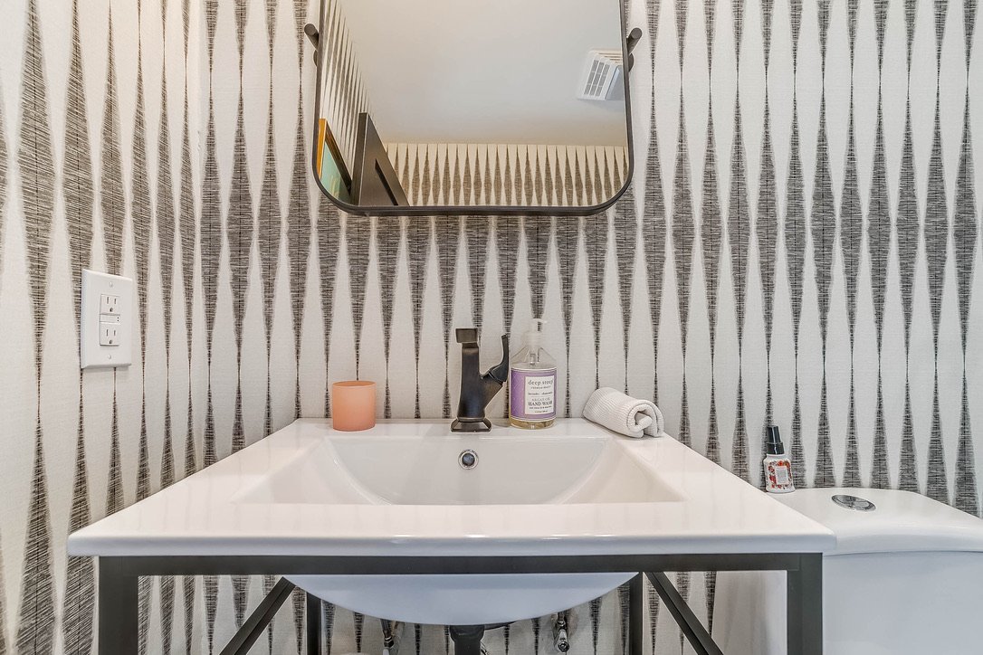 Sink counter set against vertical slat wall paneling