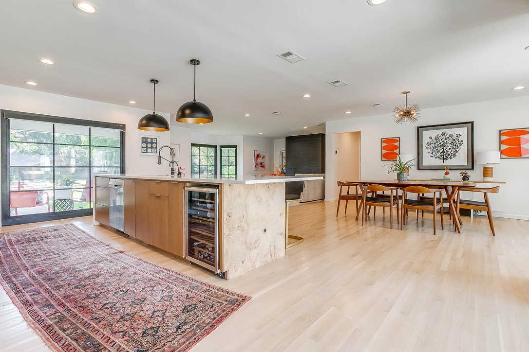 Open kitchen and dining area with hardwood flooring